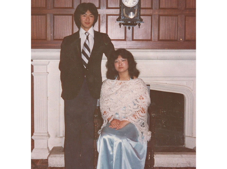 A couple pose in formal wear in a photo from the 1970s.