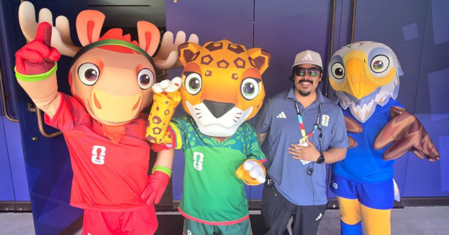 Man with three 2026 FIFA World Cup mascots