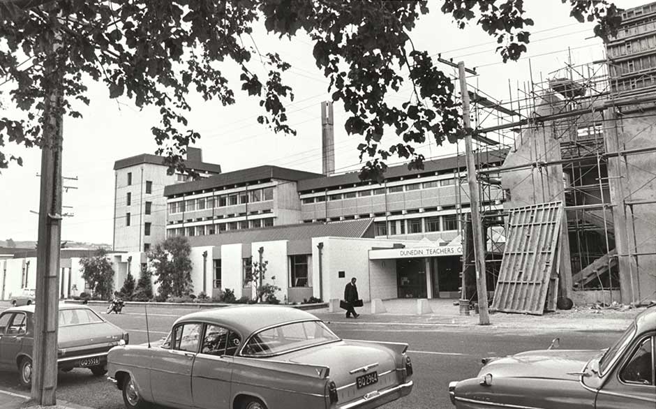 a black and white photo of a building under construction, lots of concrete
