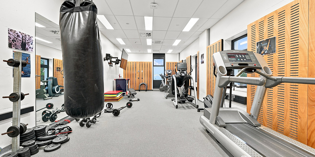 Gym are with punching bag and various gym equipment