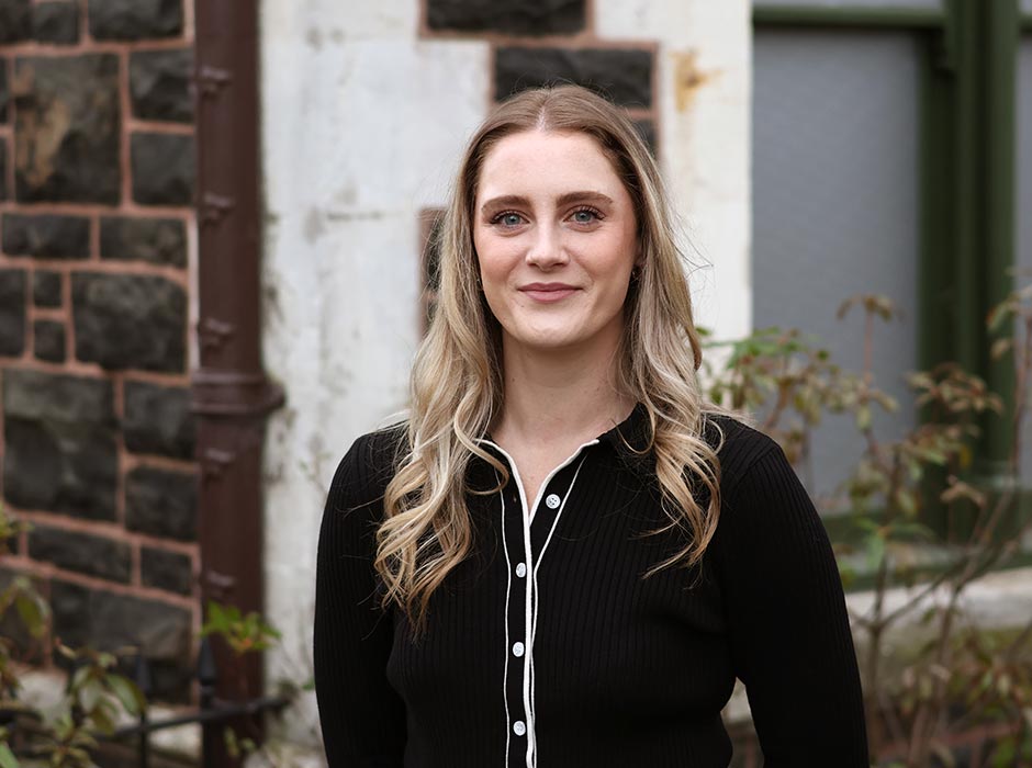 Ashlee Berryman pictured outside a University of Otago stone building.