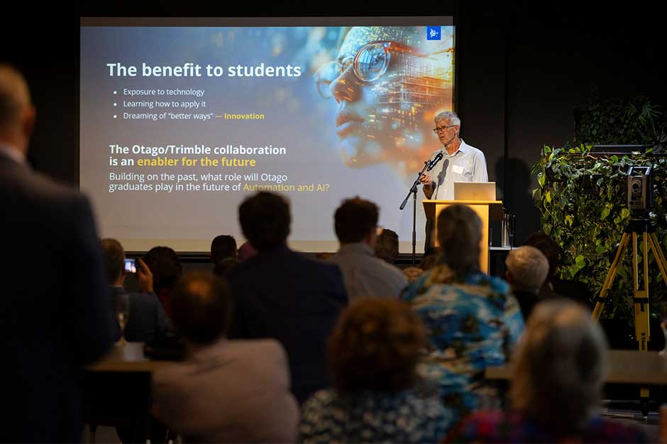 A man addresses an audience from a podium
