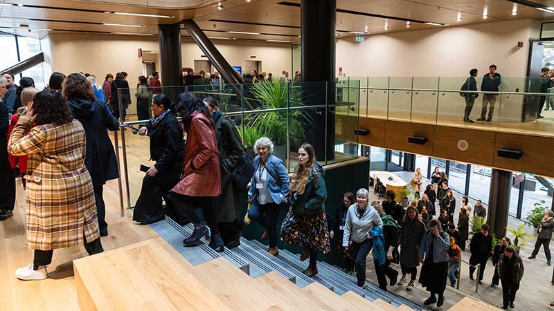 People walking up stairs to look around a building 