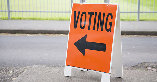 Orange and black voting sign with arrow thumbnail image