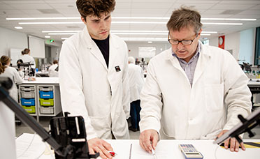 Student and teacher in lab