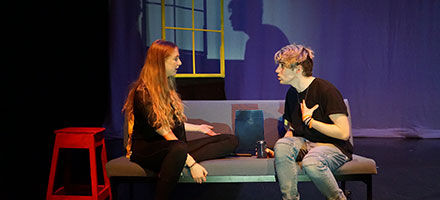 Two students talking on a couch