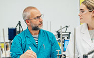 Lecturer speaking with student in lab