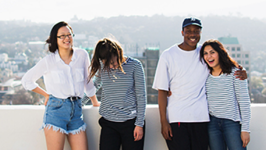 Four International students standing on a balcony