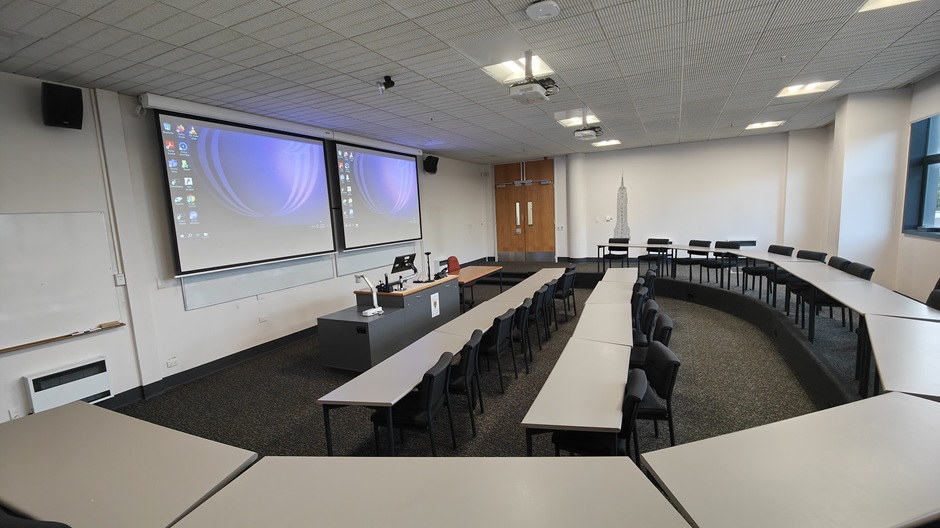 View of Otago Business School room LG04, showing tables and chairs in a small lecture theatre layout
