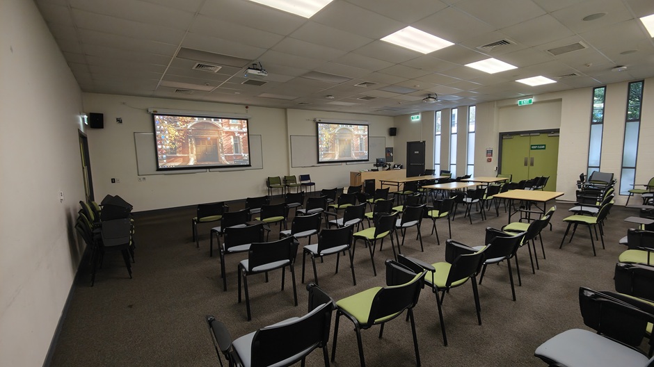 View of 71 Frederick St room 71FRG10 showing tables and chairs with individual writing surfaces