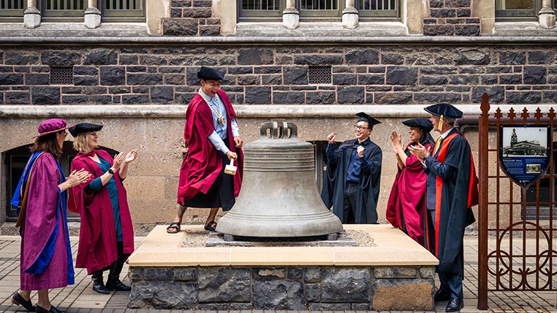 Doctoral student ringing-the-bell
