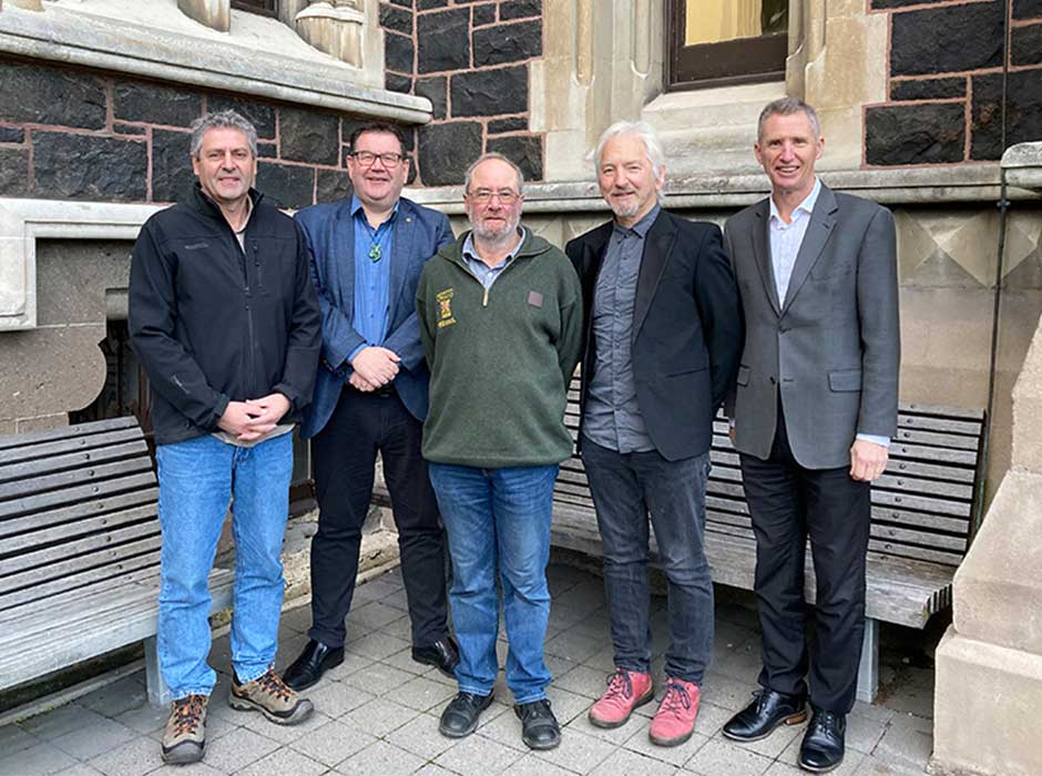 Five men standing next to each other 
