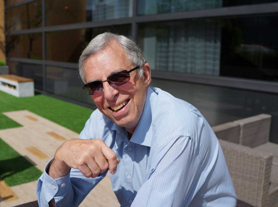 A man sitting a picnic table 