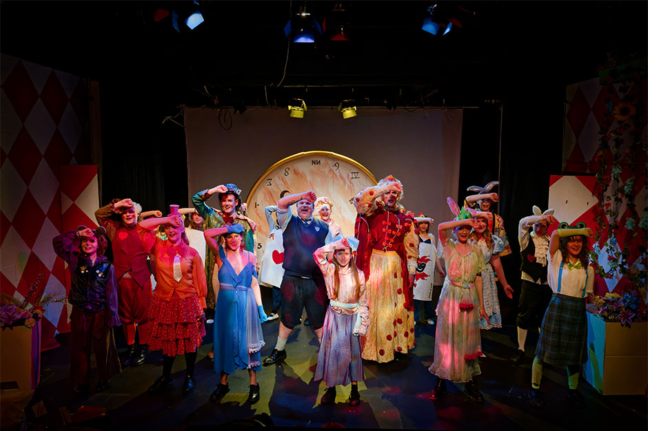 a row of people performing on stage 