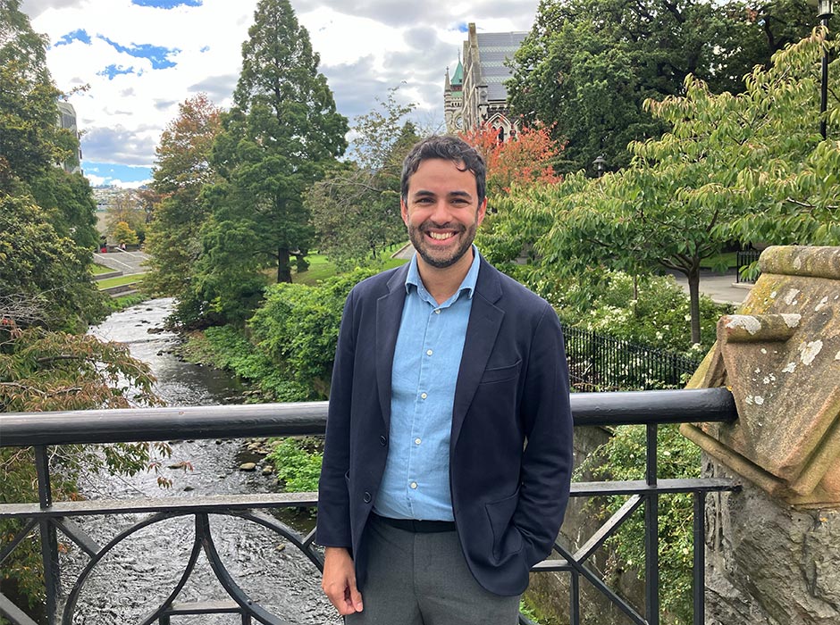 A man stands on a bridge with The Leith behind him.