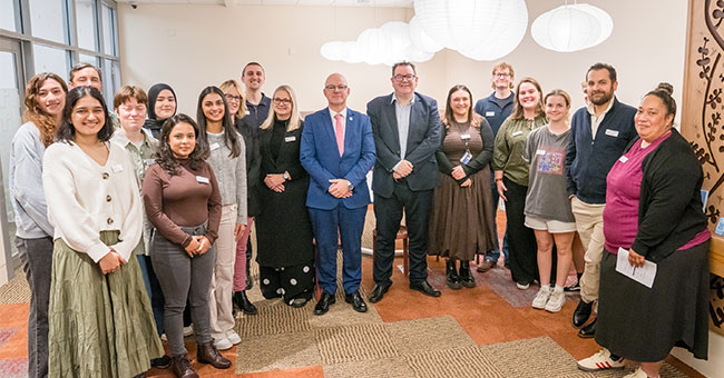 A group of staff and students gather for a photo in the new wellbeing hub.
