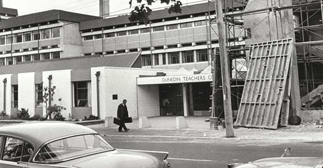 a black and white photo of a building under construction, lots of concrete