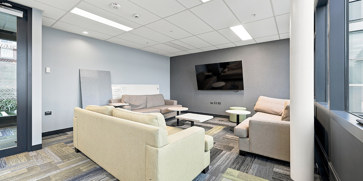 Shared lounge area with couches and TV
