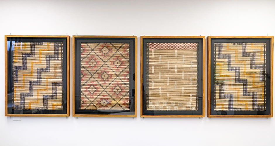 Human Nutrition kaimahi unveil the four tukutku panels in the staffroom.