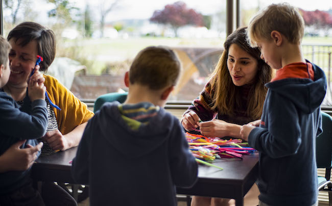 Aisha Sati shows children and parents how to make models of neurons with pipe cleaners.