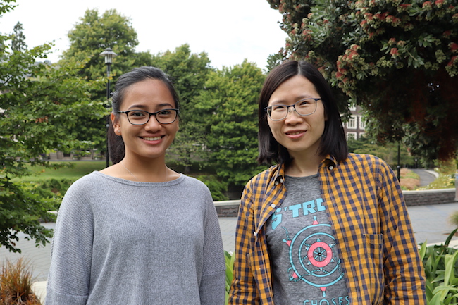 Yinghua Chen and Moitzle Ocariza standing in front of trees outside the Biochemistry building.