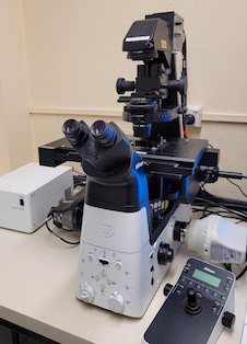 A tall microscope with multiple attachments