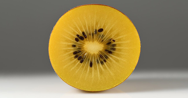 Photograph of a cross-section of a gold kiwifruit