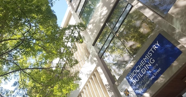 Photo of the entrance of the Biochemistry Building on a sunny day.