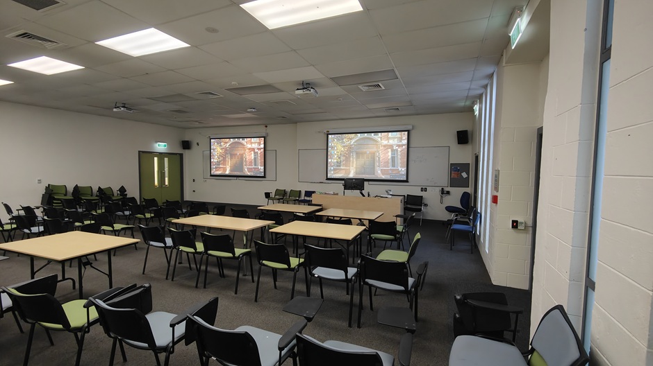 View of 71 Frederick St room 71FRG10 showing tables and chairs with individual writing surfaces