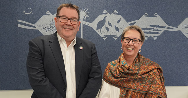 A man standing next to a woman 
