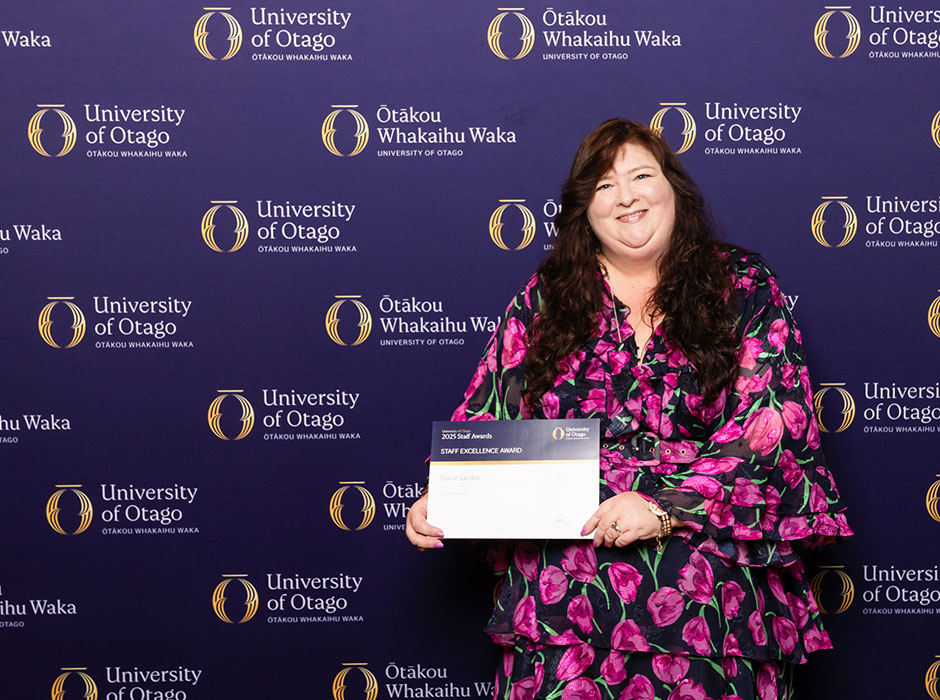 a woman holding a certificate 