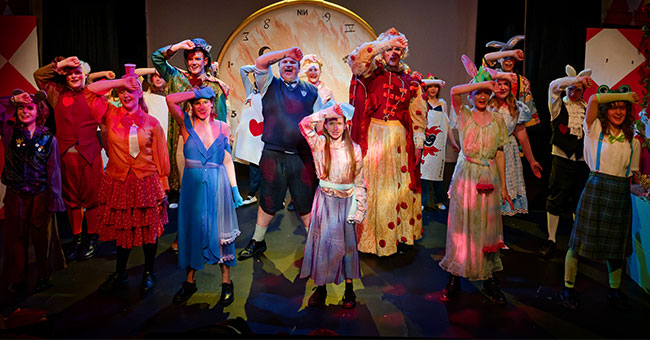 a row of people performing on stage 
