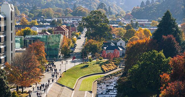 an aerial view of the walk way on the western side of the Leith, out front of the clocktower building, at autumn with students walking through