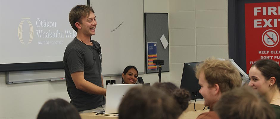 A young male speaker entertains a crowd.