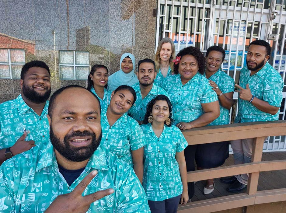 A group of people dressed wearing matching shirts.