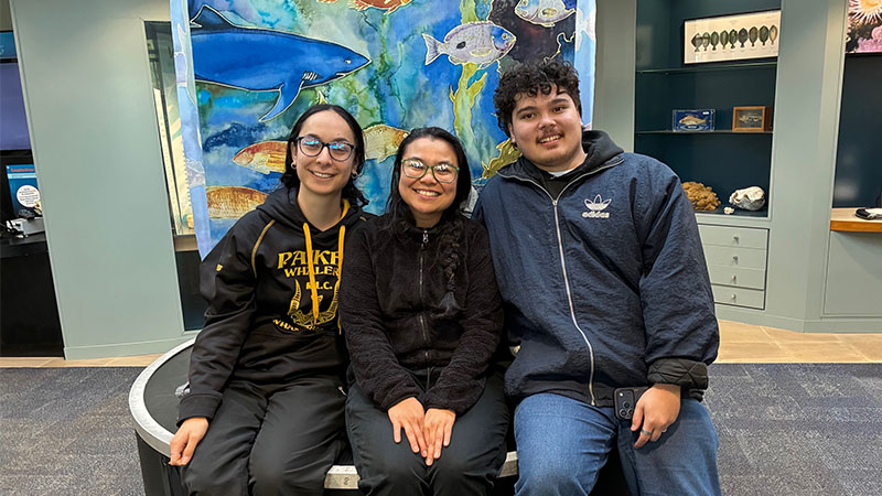 Three smiling people pose for a photo at the Portobello aquarium.