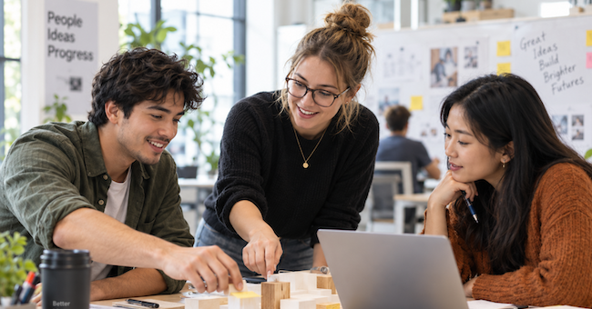Three people collaborating on a task at a table