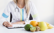 Health worker with fruit on her desk thumb