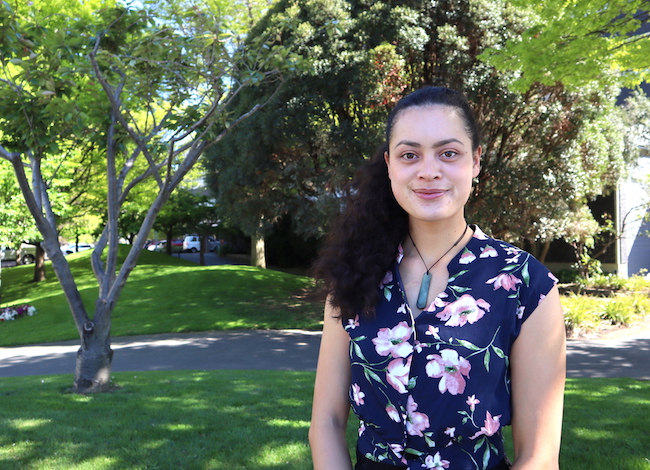 Jordon Lima standing in the garden outside the Department of Biochemistry