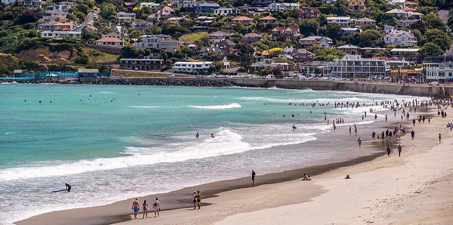 People swimming and surfing at Saint Clair Beach in Dunedin. Photo credit: Dunedin NZ.