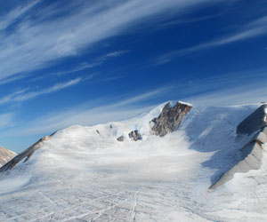 Ice covered quartzite peak in NW Greenland, we built a cairn of banded iron formation blocks on the top (carried from a unit at the base) to confuse future geologists!