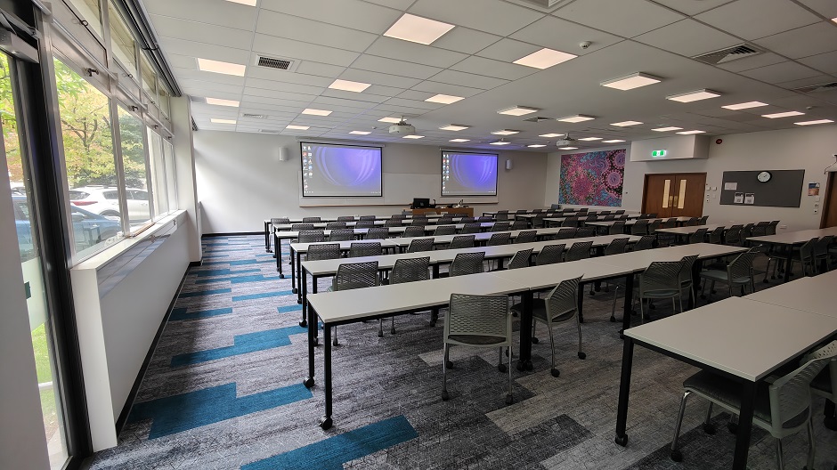 View of Biochemistry seminar room BIG13, showing rows of tables and chairs