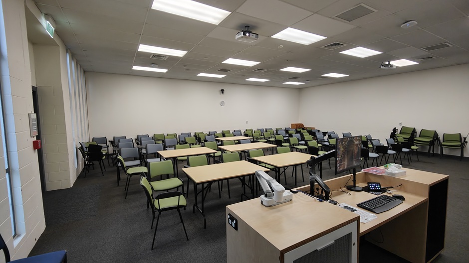 View of 71 Frederick St room 71FRG10 showing tables and chairs with individual writing surfaces