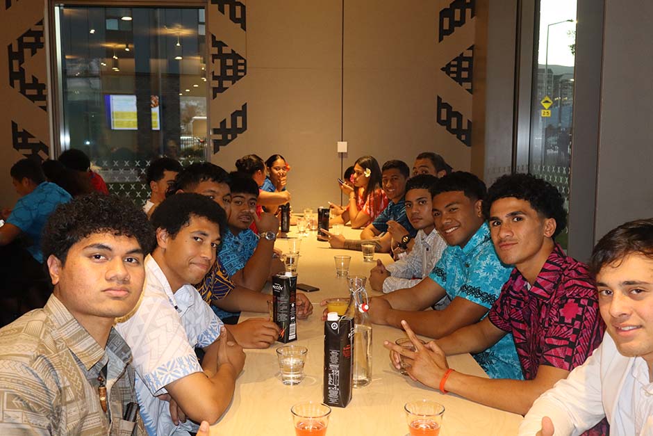 A group of male Pacific Island students sitting at a table in colourful clothing