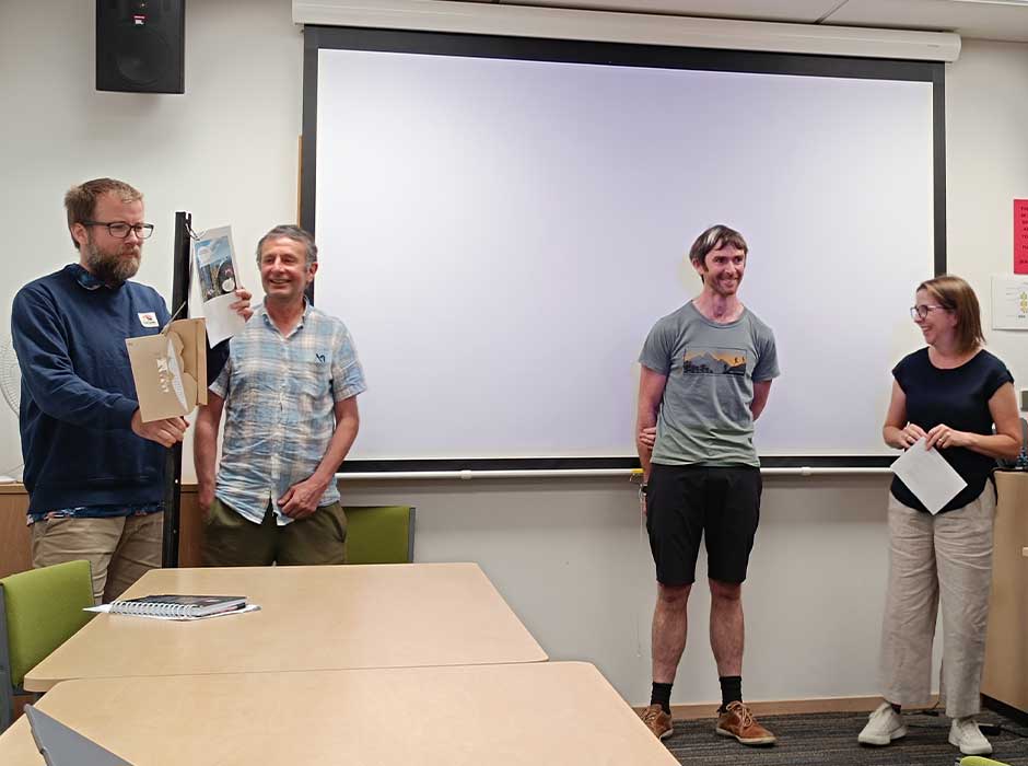 A row of people standing at the front of a classroom 