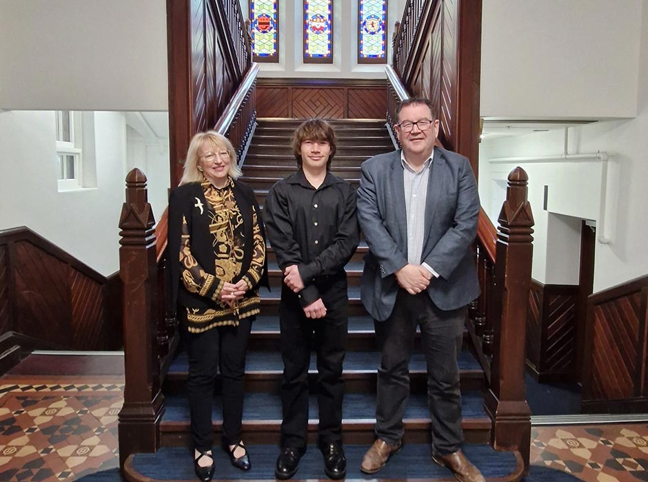 Posing for a photo in the Clocktower building are Mayor of Dunedin Sophie Barker, student Alexander Lea, and Otago Vice-Chancellor Grant Robertson