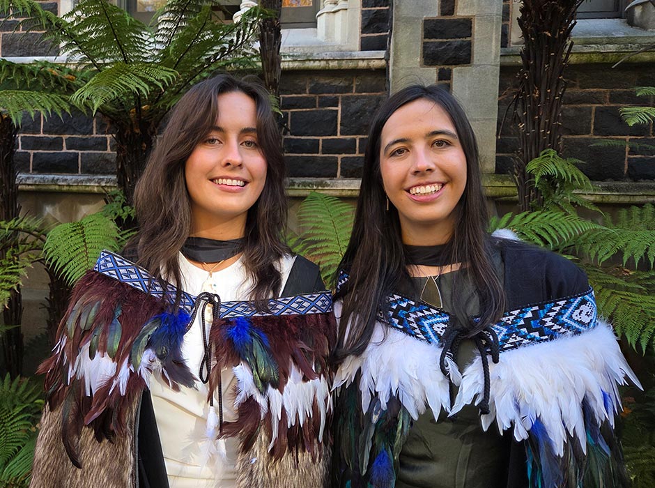 Two female graduates wearing tradition Māori korowai