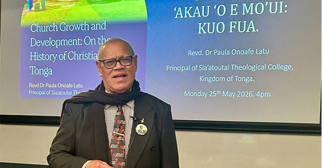 Reverend Dr Paula Onoafe Latu is pictured in front of a screen during his talk.