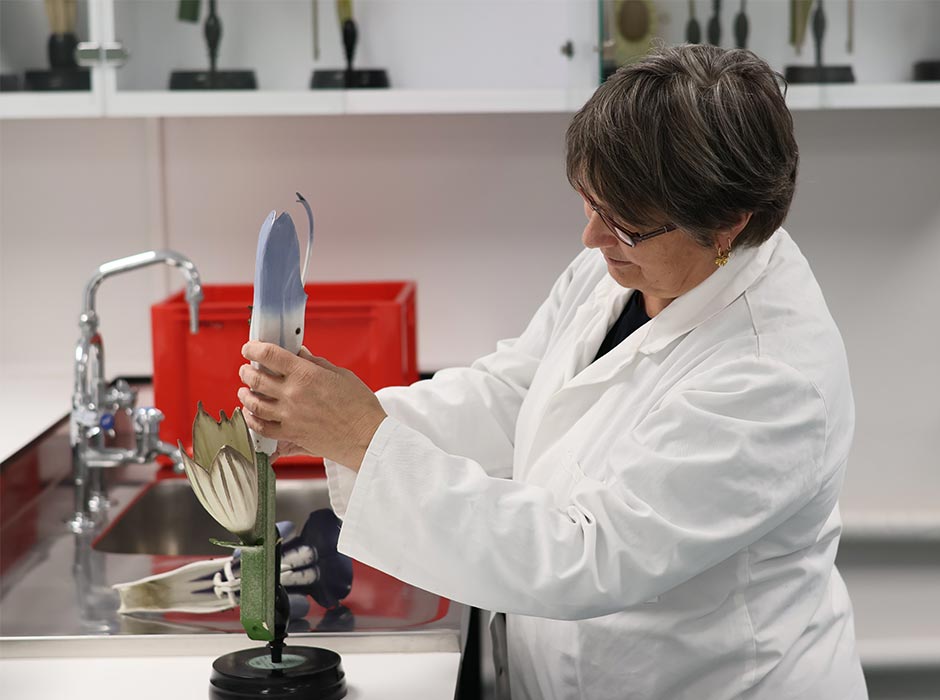 A scientist works with a model of a flower in her lab.