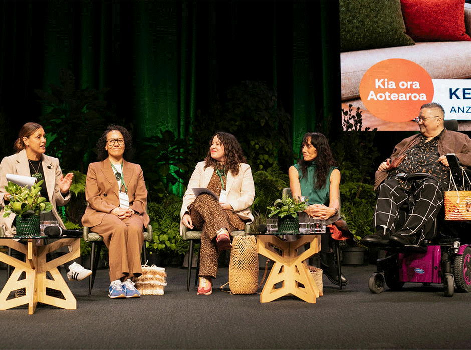 four women on stage at a conference